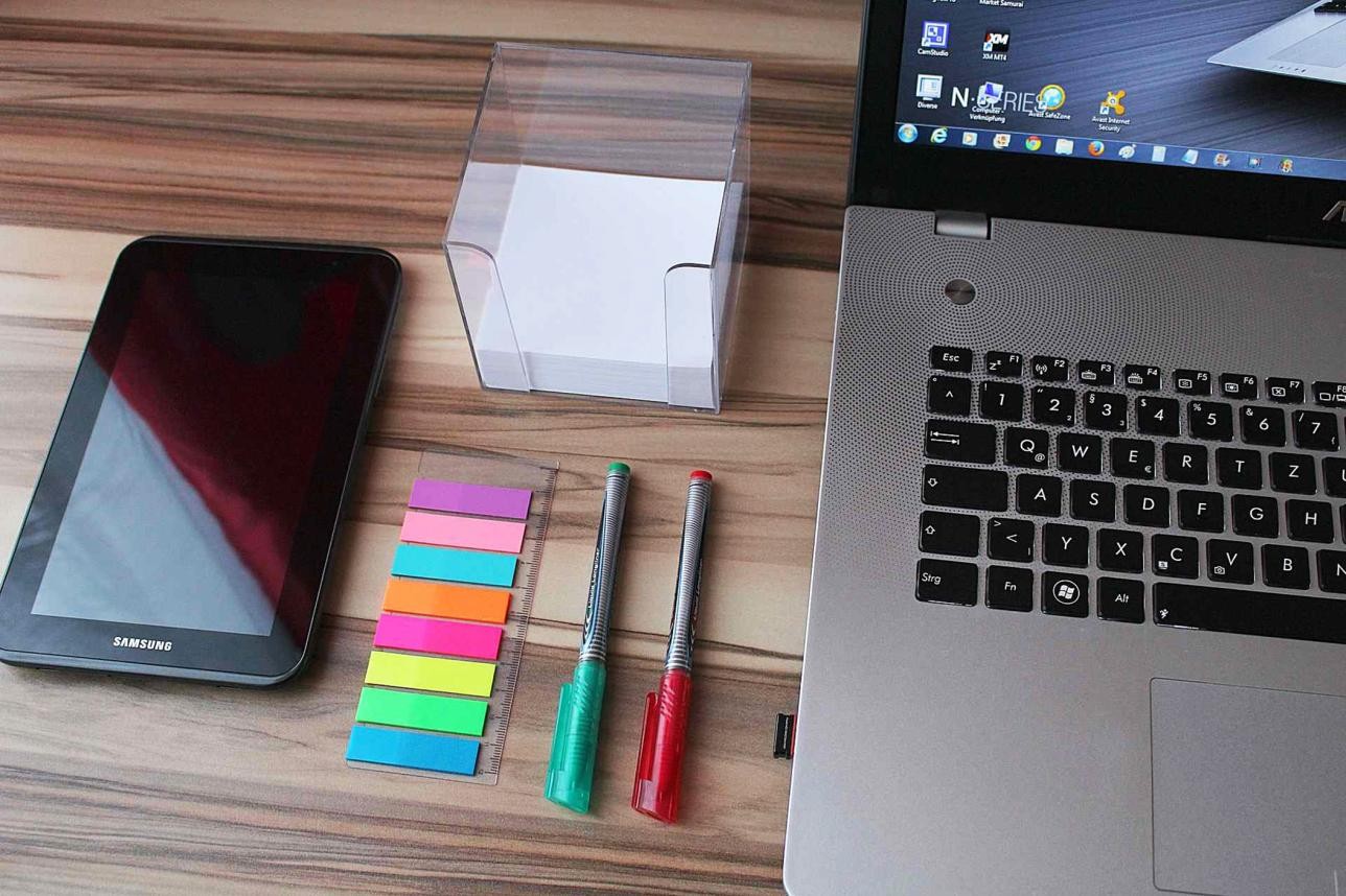 Tablet, laptop and office supplies on one table