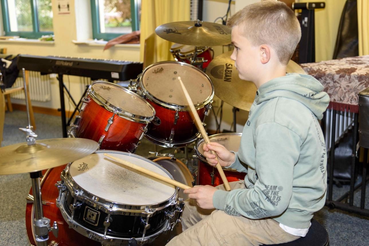 Child plays drums