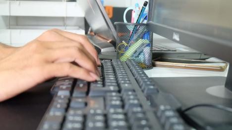 Woman typing on PC