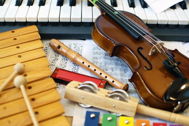 Foto mit verschiedenen Instrumenten - von Geige über Keyboard und Blockflöte bis Glockenspiel.